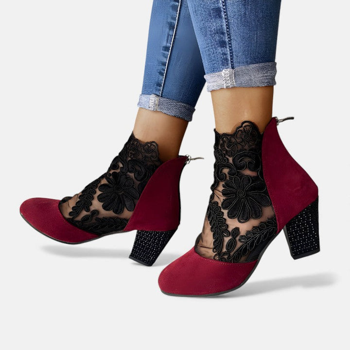 A woman wearing wide-toe orthopaedic heels, standing comfortably in an elegant everyday look.