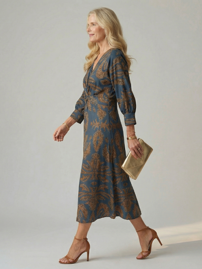 Dark green long-sleeve midi dress with diagonal wrap bodice and straight skirt in a detailed print