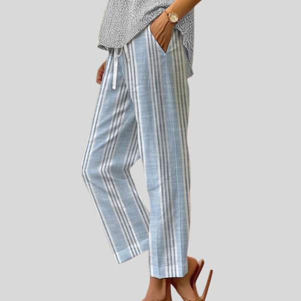 Woman wearing light blue and white vertically striped trousers with a soft top.