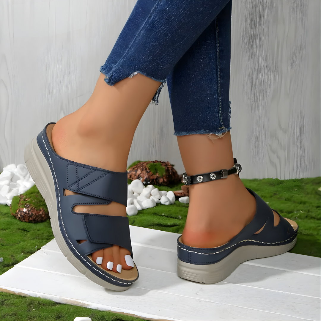Backless wedge sandals in blue with two open-work straps and a cushioned sole