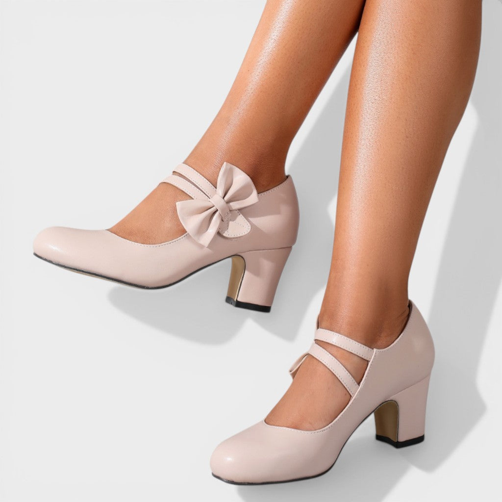 Women's mid-height heels in black with a soft delicate bow at the toe