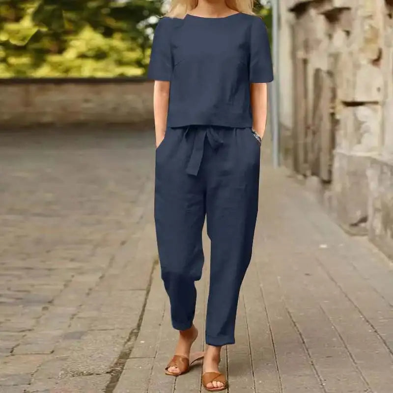 A woman wearing a relaxed short-sleeve top and matching drawstring trousers lounge set.