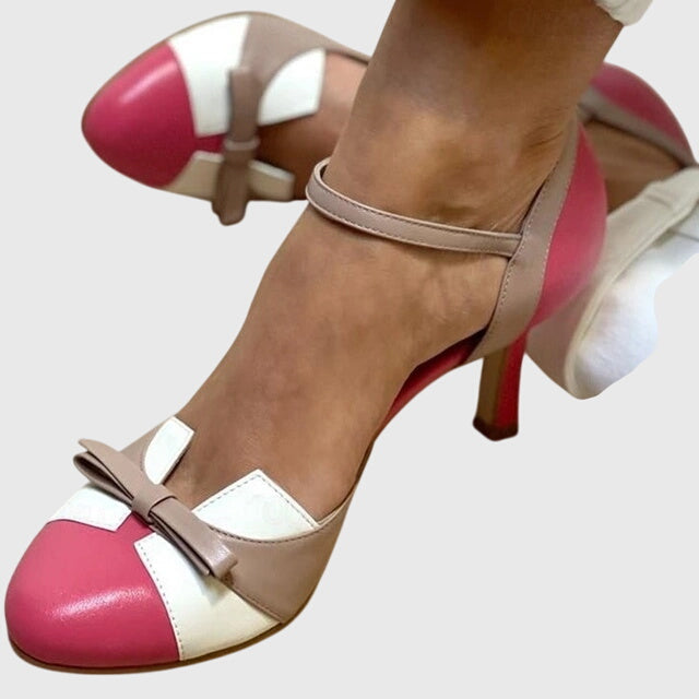 A woman wearing feminine heeled sandals with a summer occasion outfit