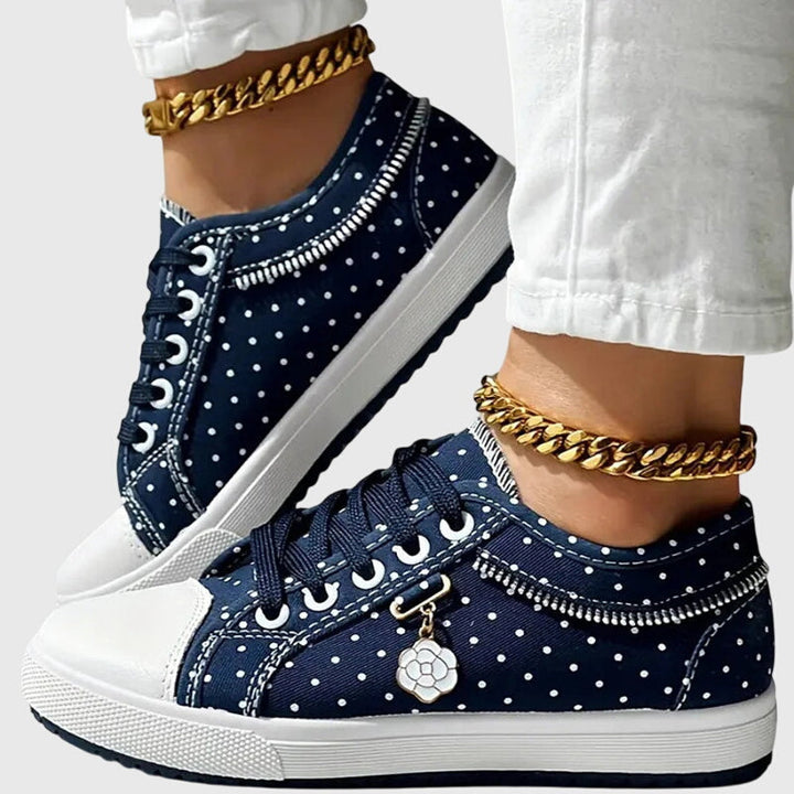 A woman walking comfortably in blue cushioned orthopaedic trainers