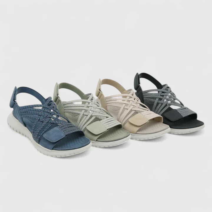 Blue open-toe sandals with woven stretch straps and a broad, cushioned white sole.