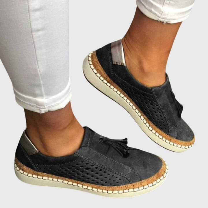 A woman wearing comfortable orthopaedic slip-on shoes on a summer day