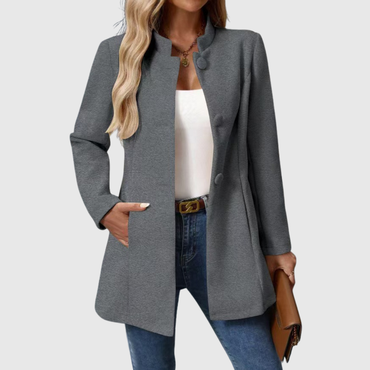 A woman wearing a collarless tailored jacket with a button front