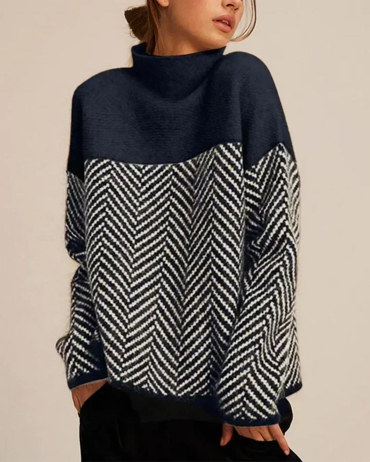 A woman wearing a zigzag-pattern funnel neck jumper styled elegantly for an autumn day out.