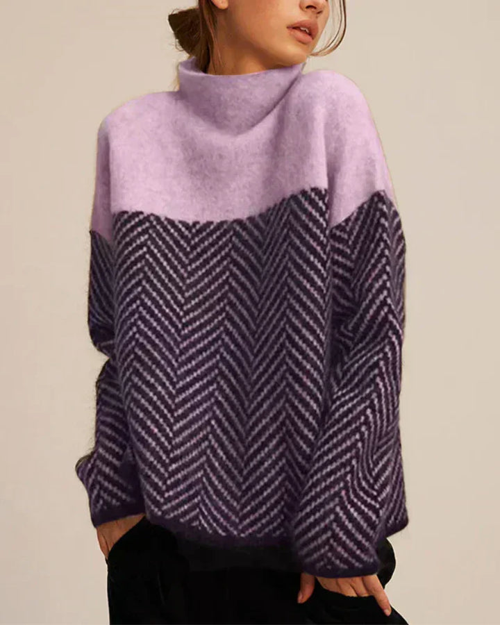 A woman wearing a zigzag-pattern funnel neck jumper styled elegantly for an autumn day out.