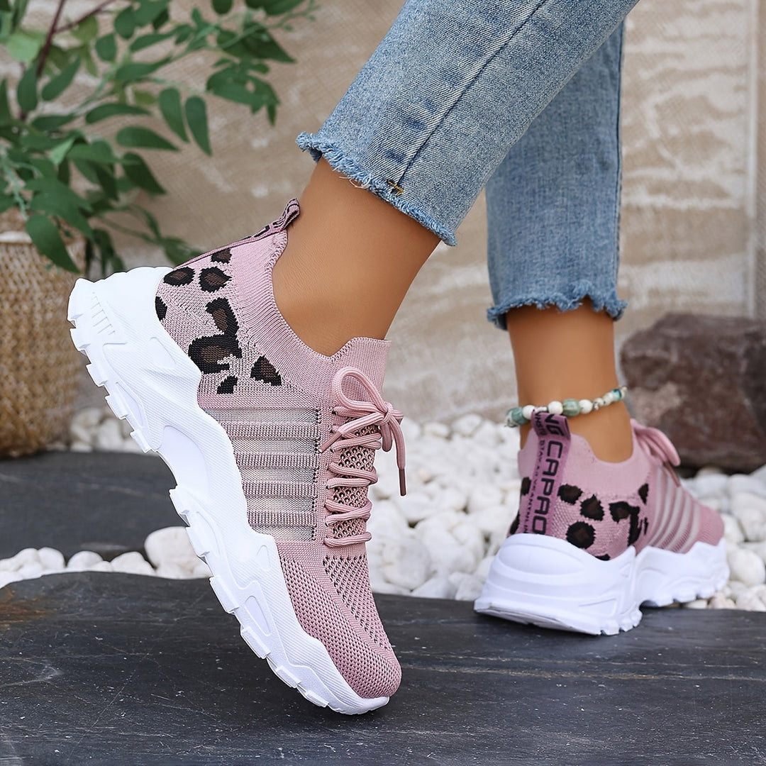 A woman walking in light, breathable comfort trainers on a warm day.