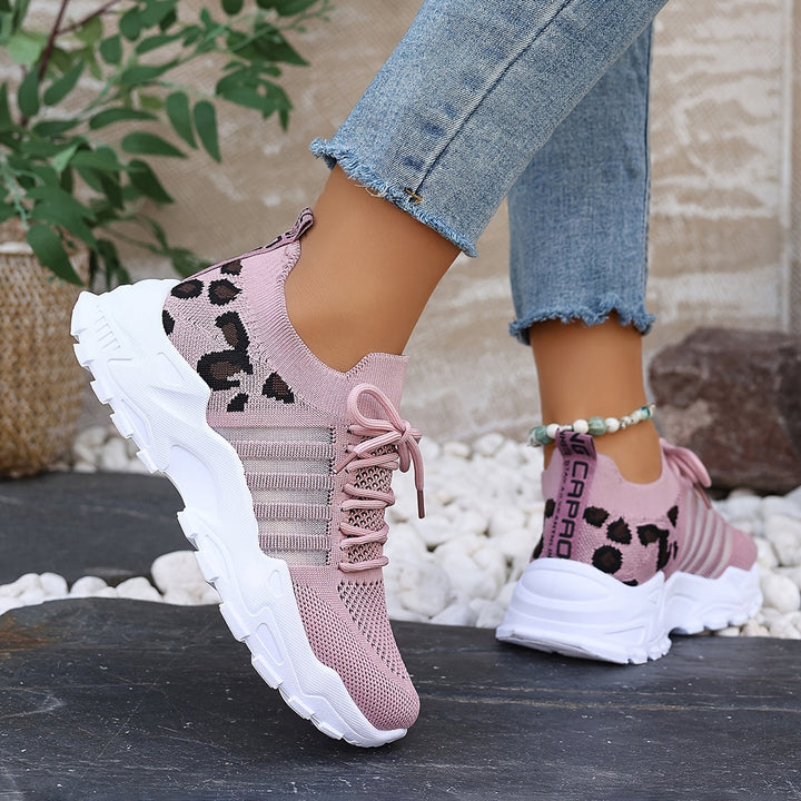 A woman walking in light, breathable comfort trainers on a warm day.