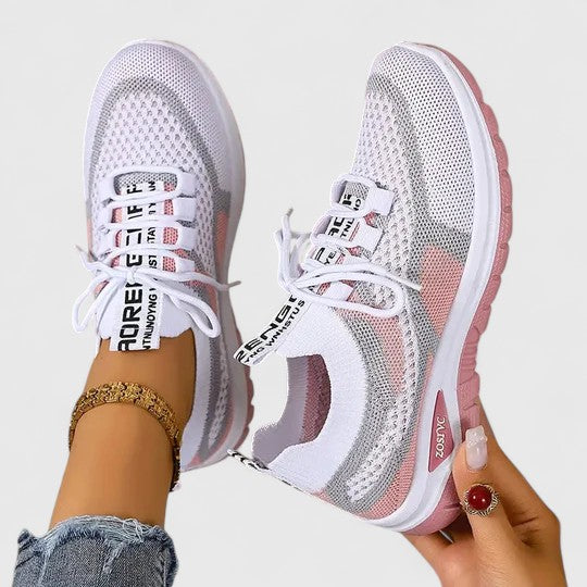A woman lacing up light, breathable orthopaedic trainers before a walk.