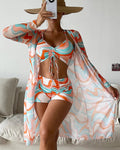 Tropical print three-piece bikini set with matching cover-up in orange and green print