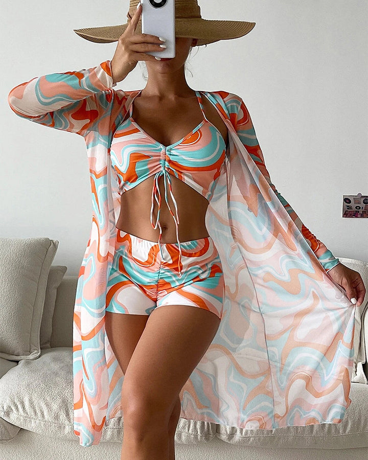 Tropical print three-piece bikini set with matching cover-up in orange and green print