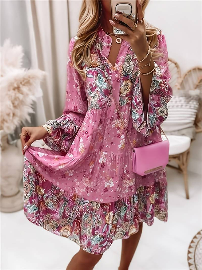 Woman in a relaxed boho dress with a colourful paisley and floral print.