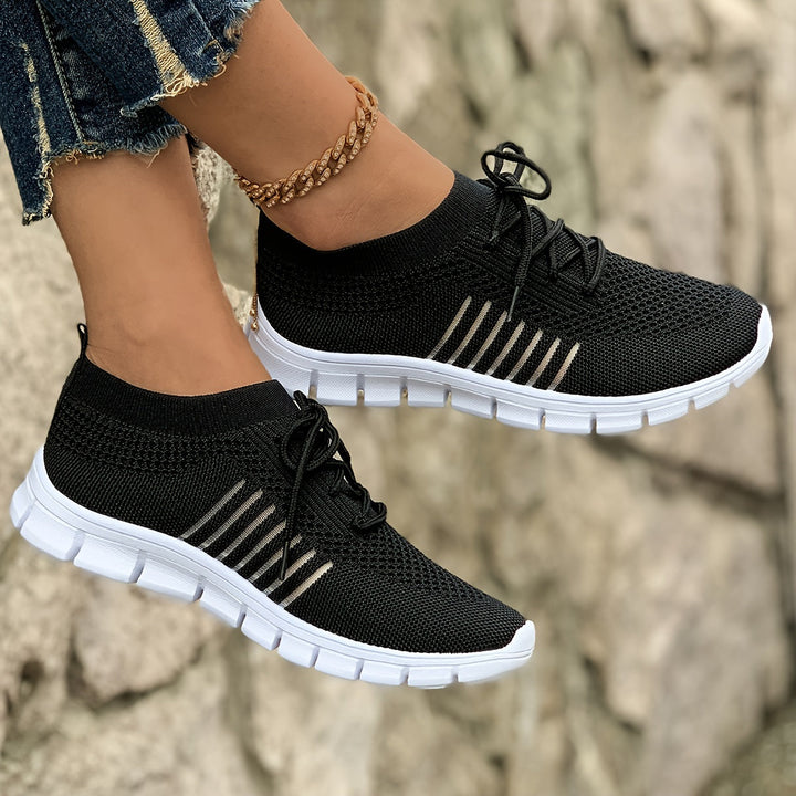 A woman wearing light breathable sock-style comfort shoes