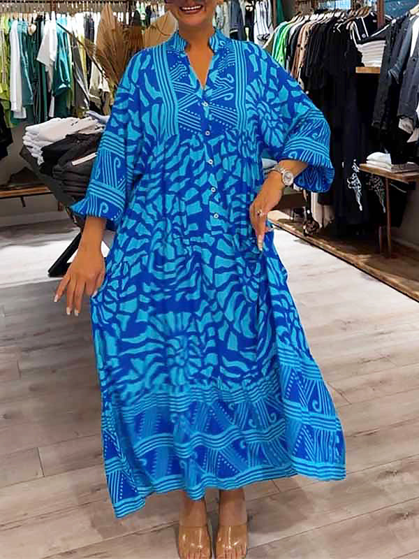 Woman wearing the Oonagh™ vivid printed maxi dress with a button front, standing confidently outdoors.