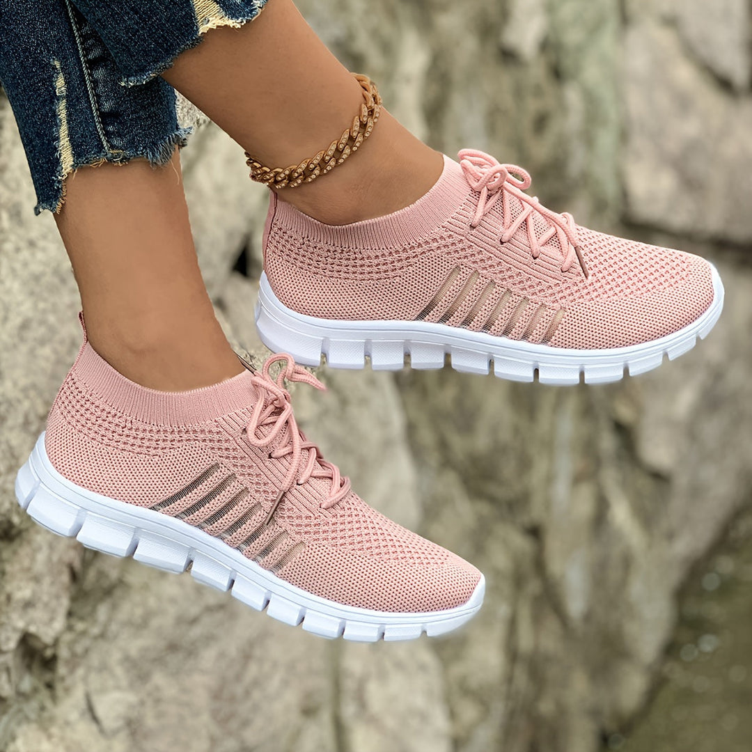 A woman wearing light breathable sock-style comfort shoes