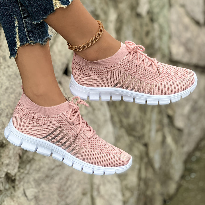 A woman wearing light breathable sock-style comfort shoes