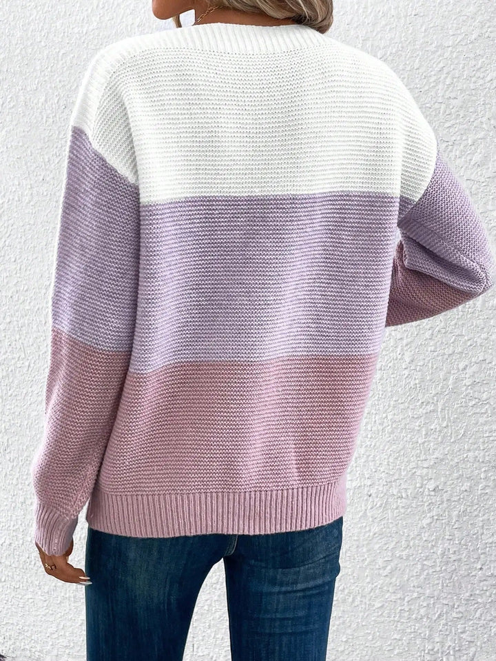 A woman wearing a soft ombré jumper with graduated shades, draping gracefully over her figure.