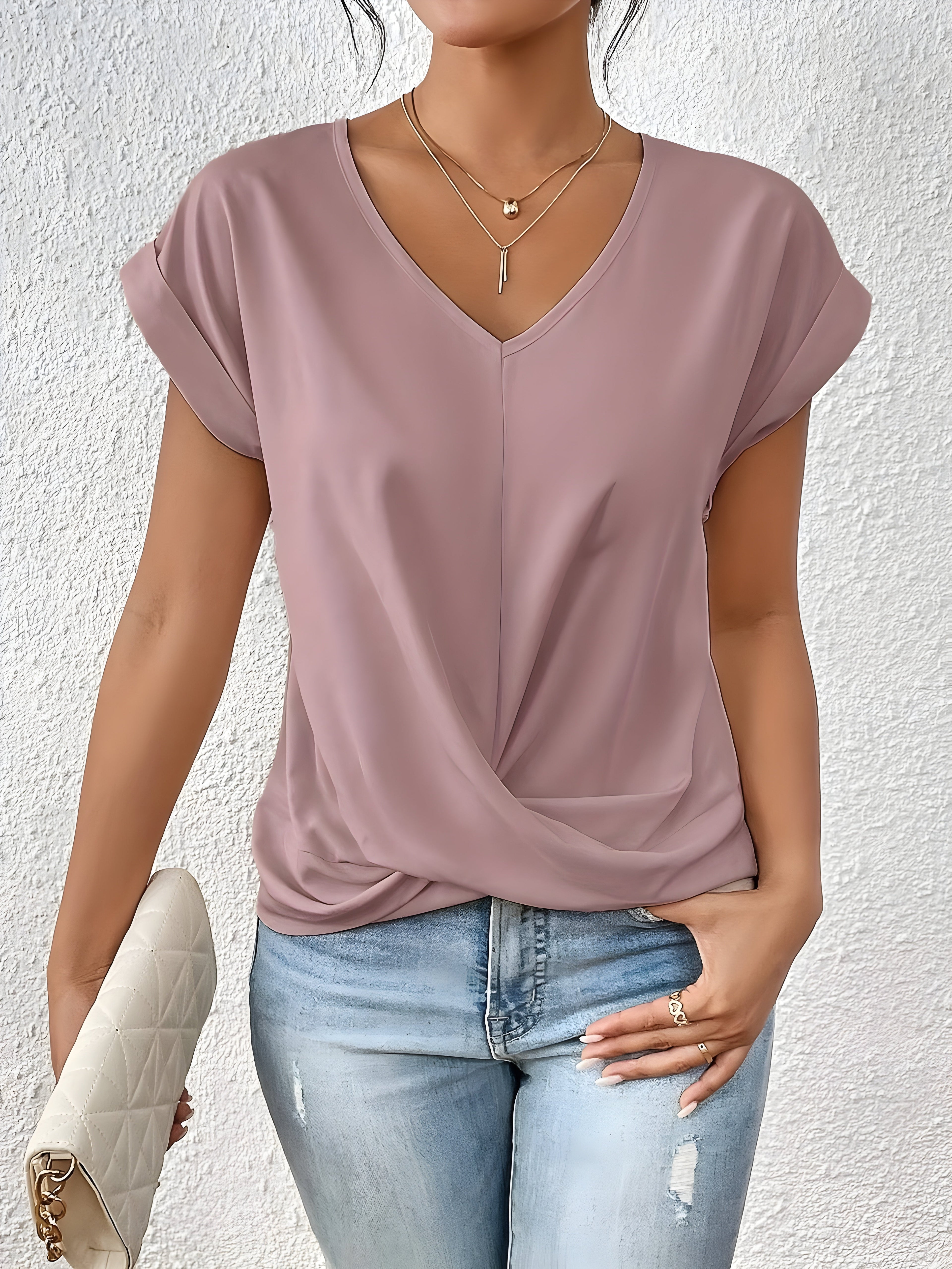 Pink V-neck top with a crossover-front detail and a relaxed, flattering silhouette