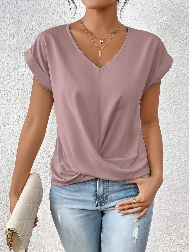 Pink V-neck top with a crossover-front detail and a relaxed, flattering silhouette