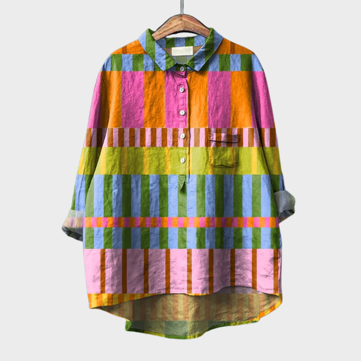 Woman wearing a colourful multicolour checked summer blouse with a soft, airy drape.