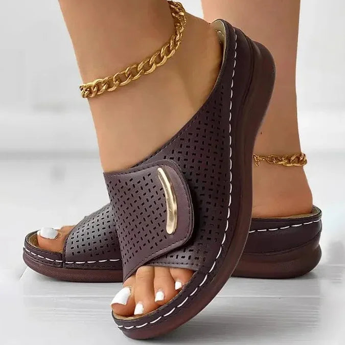 Open-work wedge sandals in bordeaux with a small metallic ornament on the upper