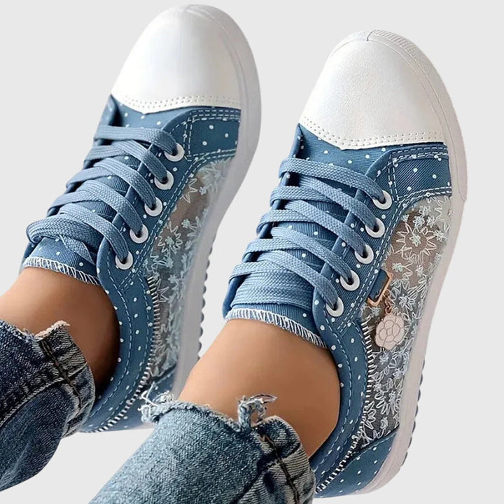 A woman walking comfortably in blue cushioned orthopaedic trainers