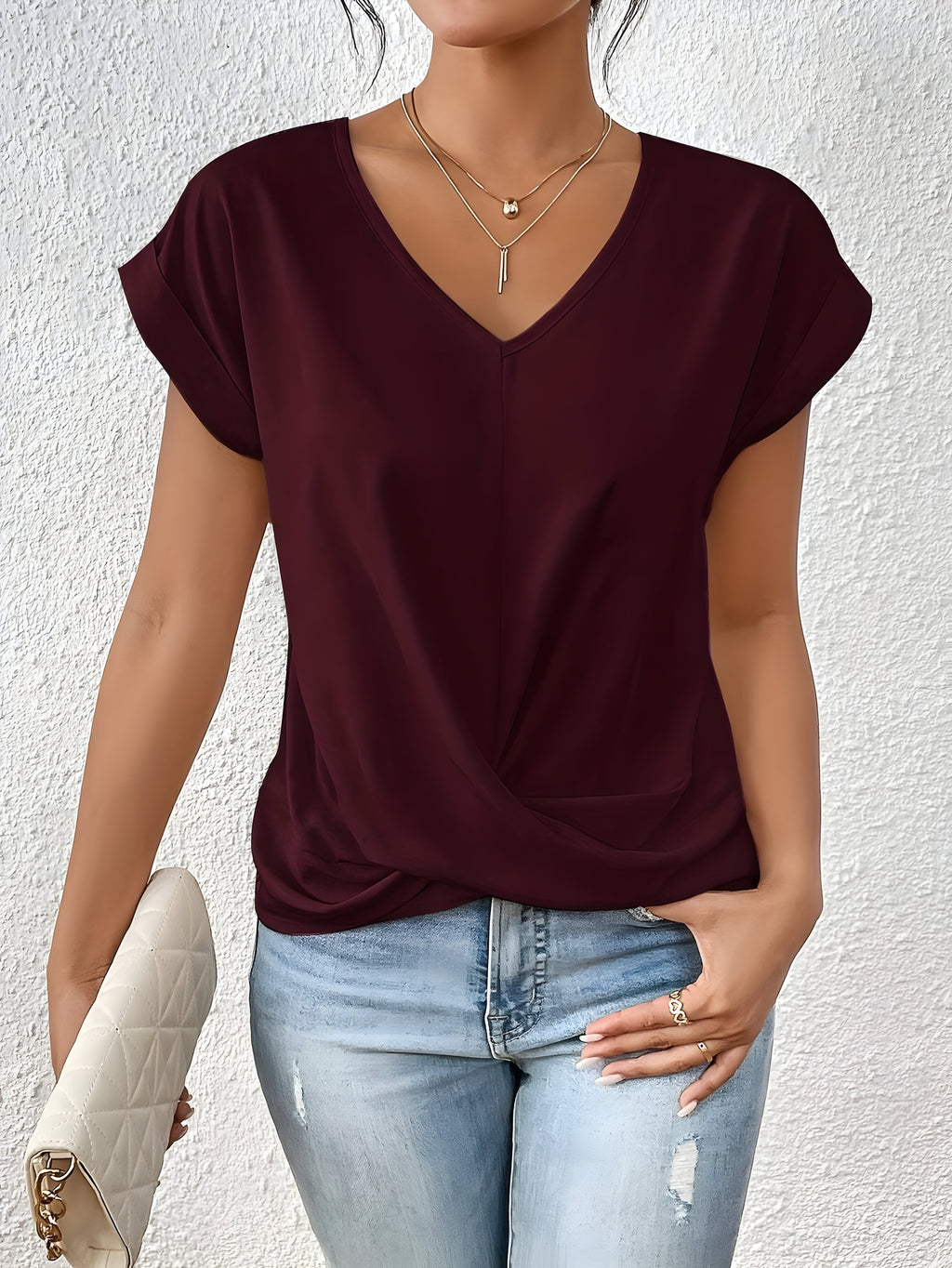 Pink V-neck top with a crossover-front detail and a relaxed, flattering silhouette