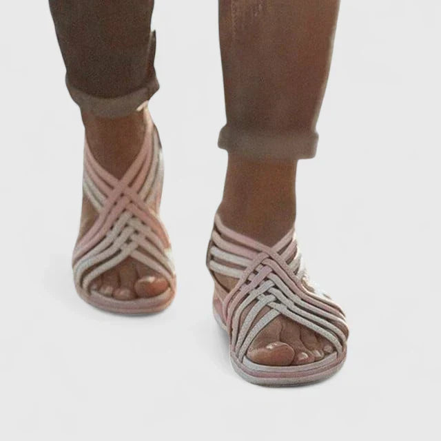 A woman walking with ease in elegant wide-fit everyday sandals with a cushioned footbed.