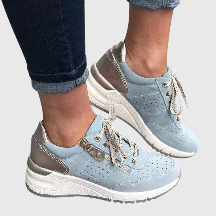 A woman on a walk wearing soft, supportive trainers on a bright day.
