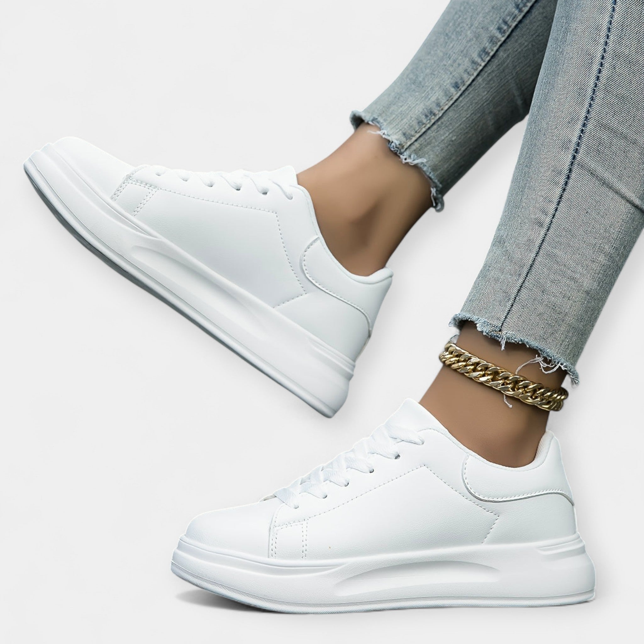 Women's classic white trainers with a clean minimal design and cushioned support sole