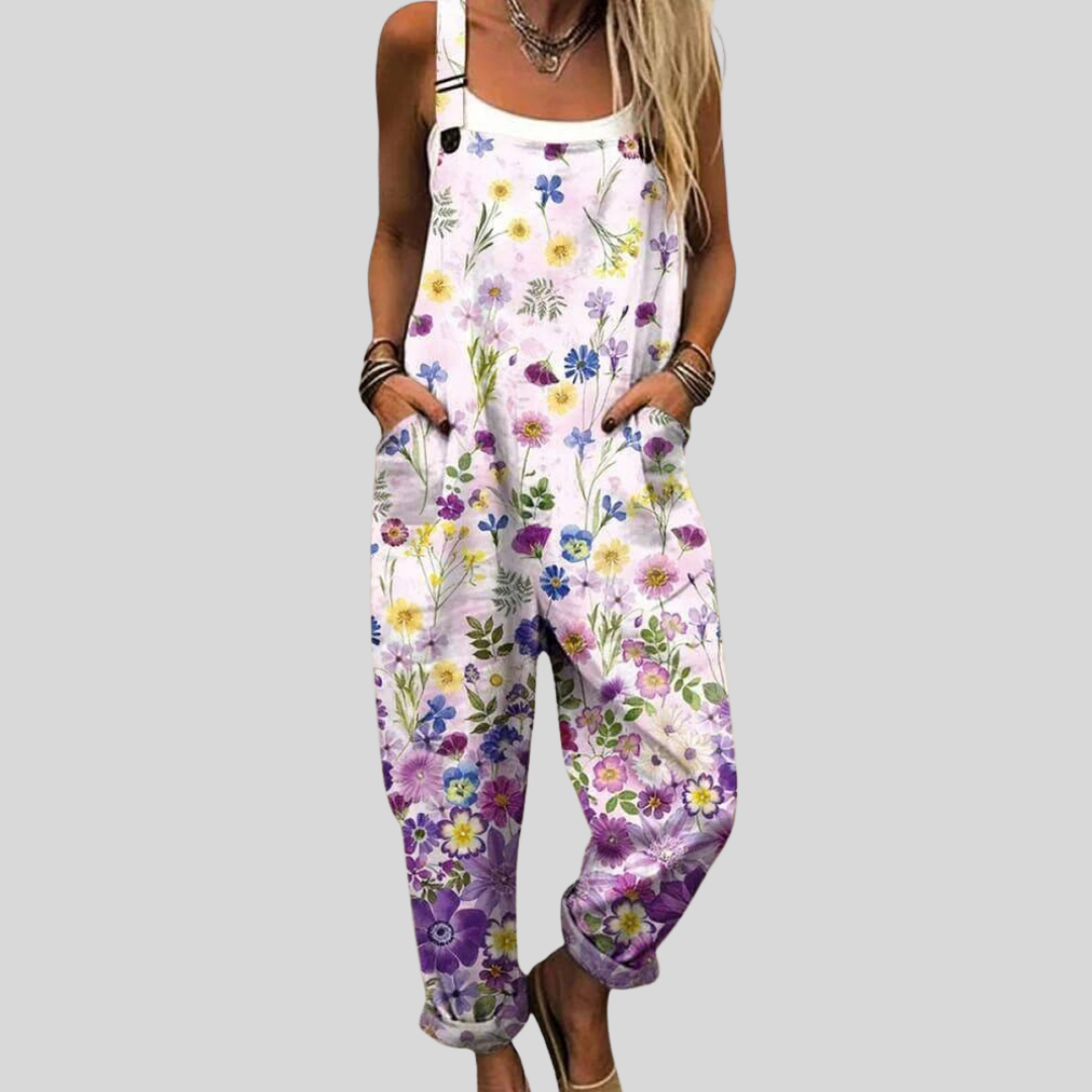 Women's relaxed wide-leg dungarees in white with a colourful scattered wildflower print in yellow, orange, pink, blue and purple.