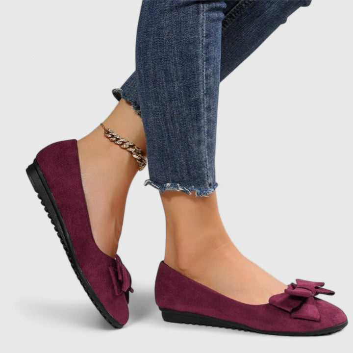 A woman walking easily in dark green classic comfort sandals with a broad, cushioned footbed.