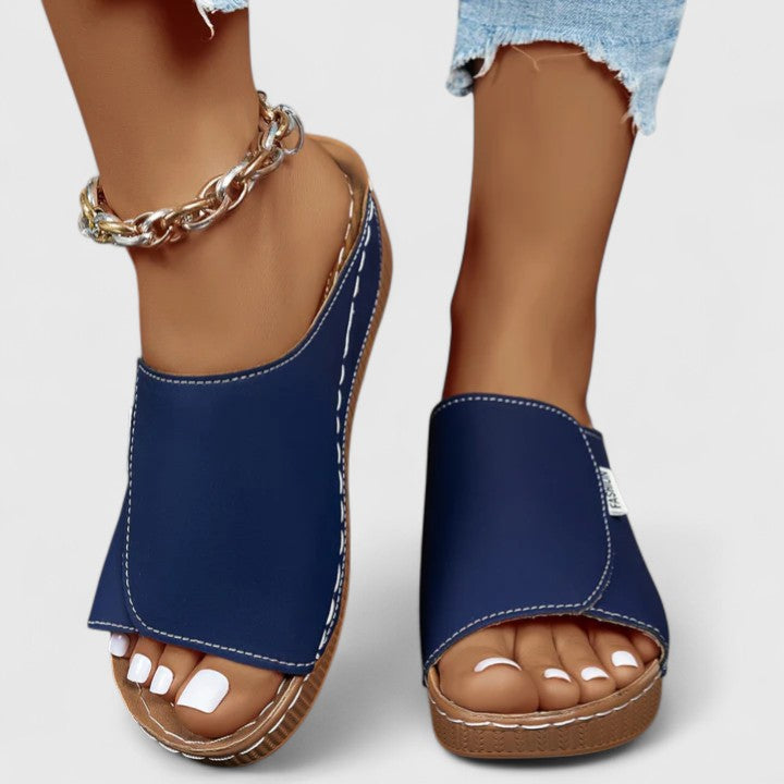 A woman in tan lightweight sandals stepping out gracefully, feet cushioned and supported.