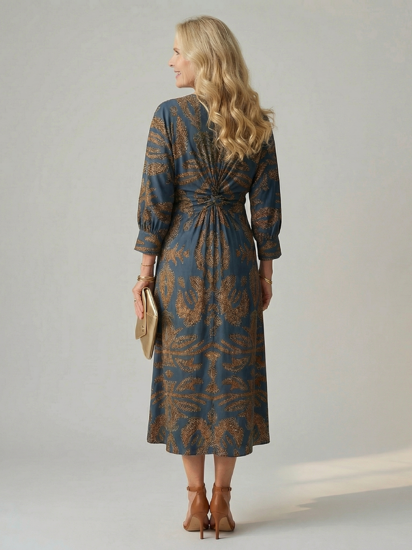 Dark green long-sleeve midi dress with diagonal wrap bodice and straight skirt in a detailed print