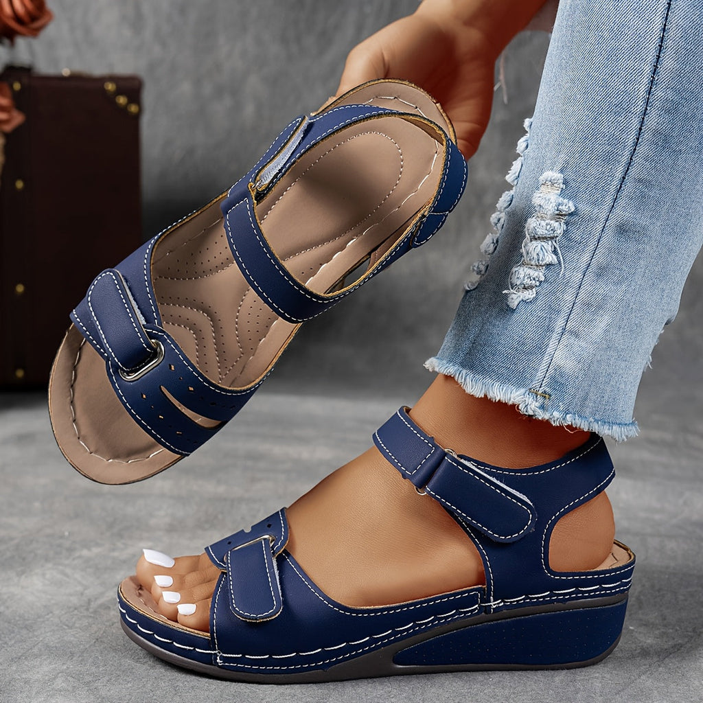 Wedge sandals with three adjustable velcro straps in a warm camel tone