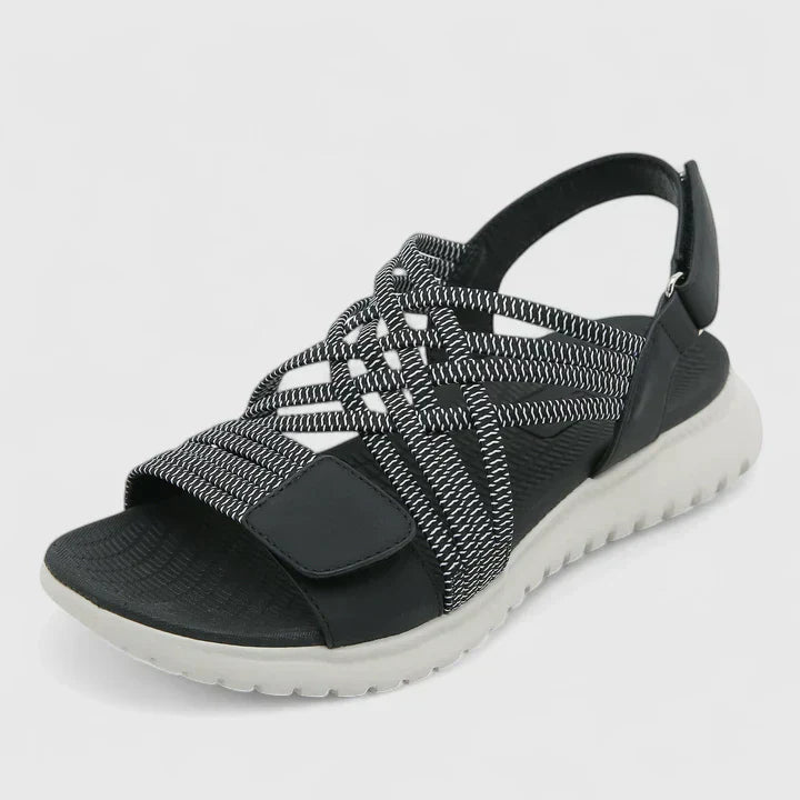 Blue open-toe sandals with woven stretch straps and a broad, cushioned white sole.