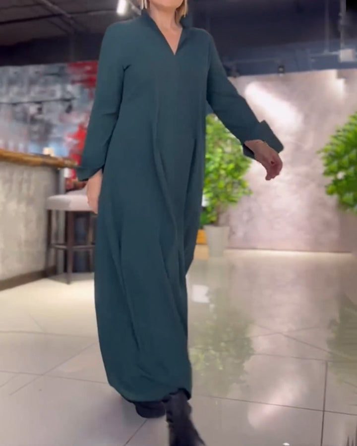 Woman wearing the Sarah relaxed maxi dress with revere collar, standing by a doorway.