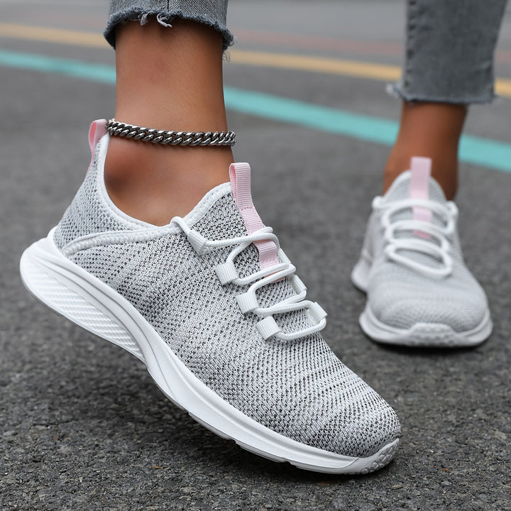 A woman walking comfortably in lightweight breathable trainers with trousers