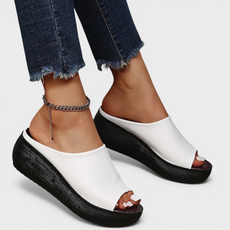 Open wedge mule sandals in white and brown with wide straps and a balanced wedge sole