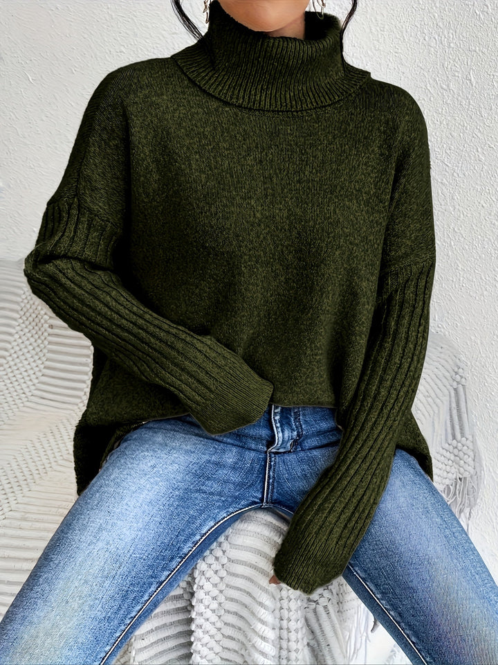 A woman wearing a stand-collar jumper with a chic asymmetric drape, warm and polished.