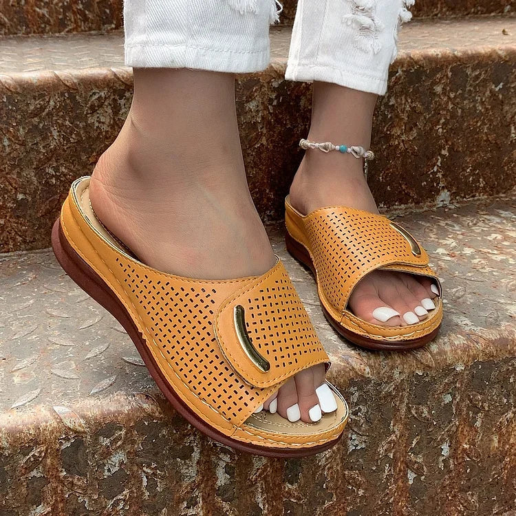 Open-work wedge sandals in bordeaux with a small metallic ornament on the upper