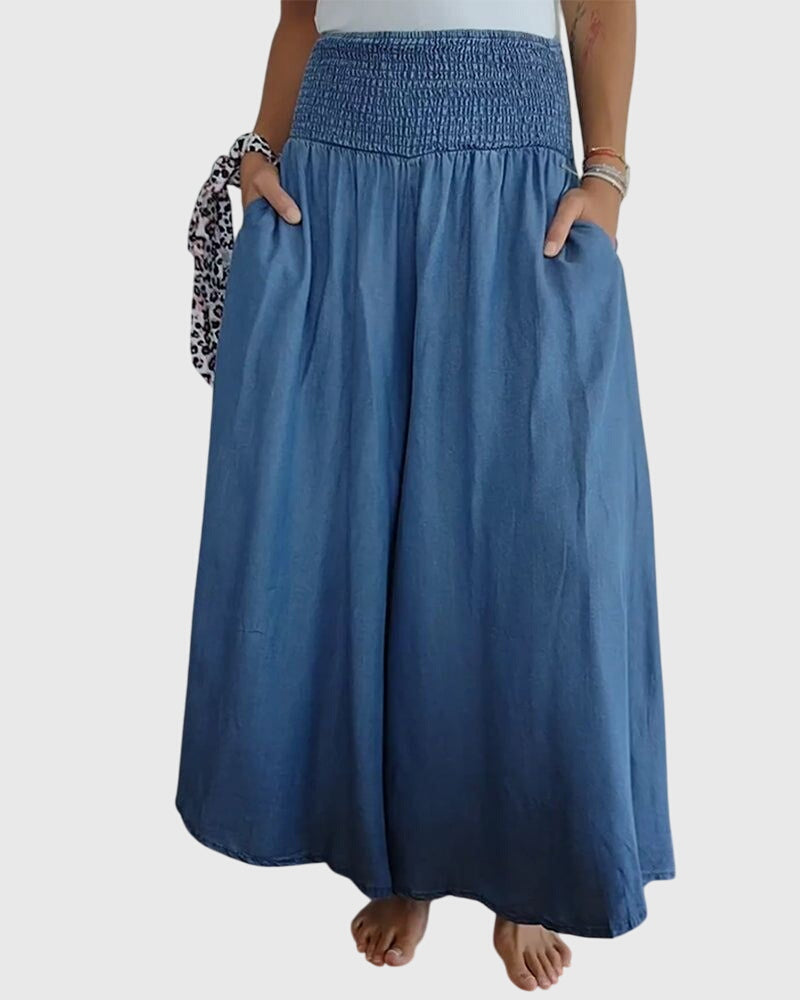A woman in wide-leg trousers with a high elastic waist, styled for a relaxed boho look.