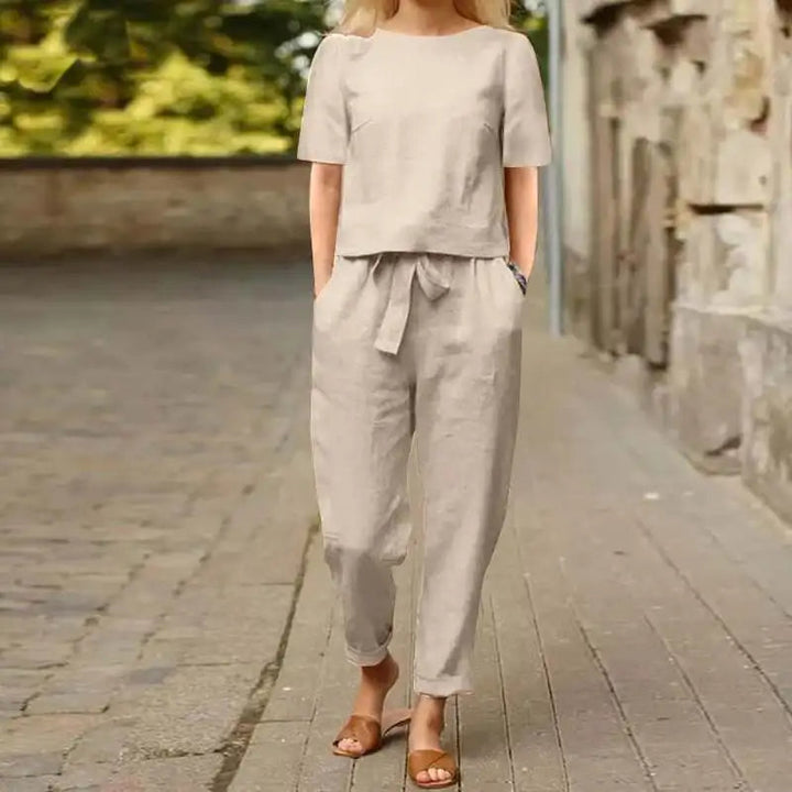A woman wearing a relaxed short-sleeve top and matching drawstring trousers lounge set.