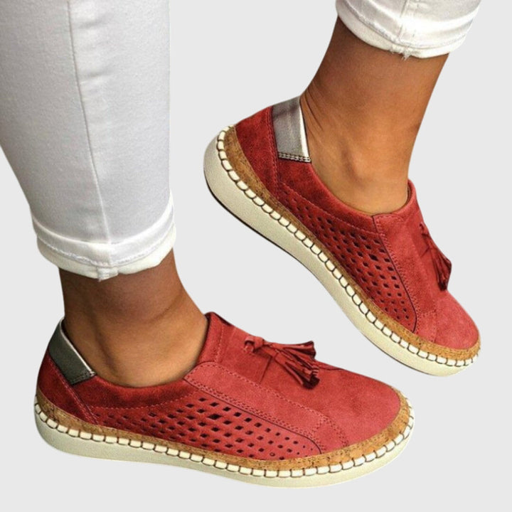 A woman wearing comfortable orthopaedic slip-on shoes on a summer day