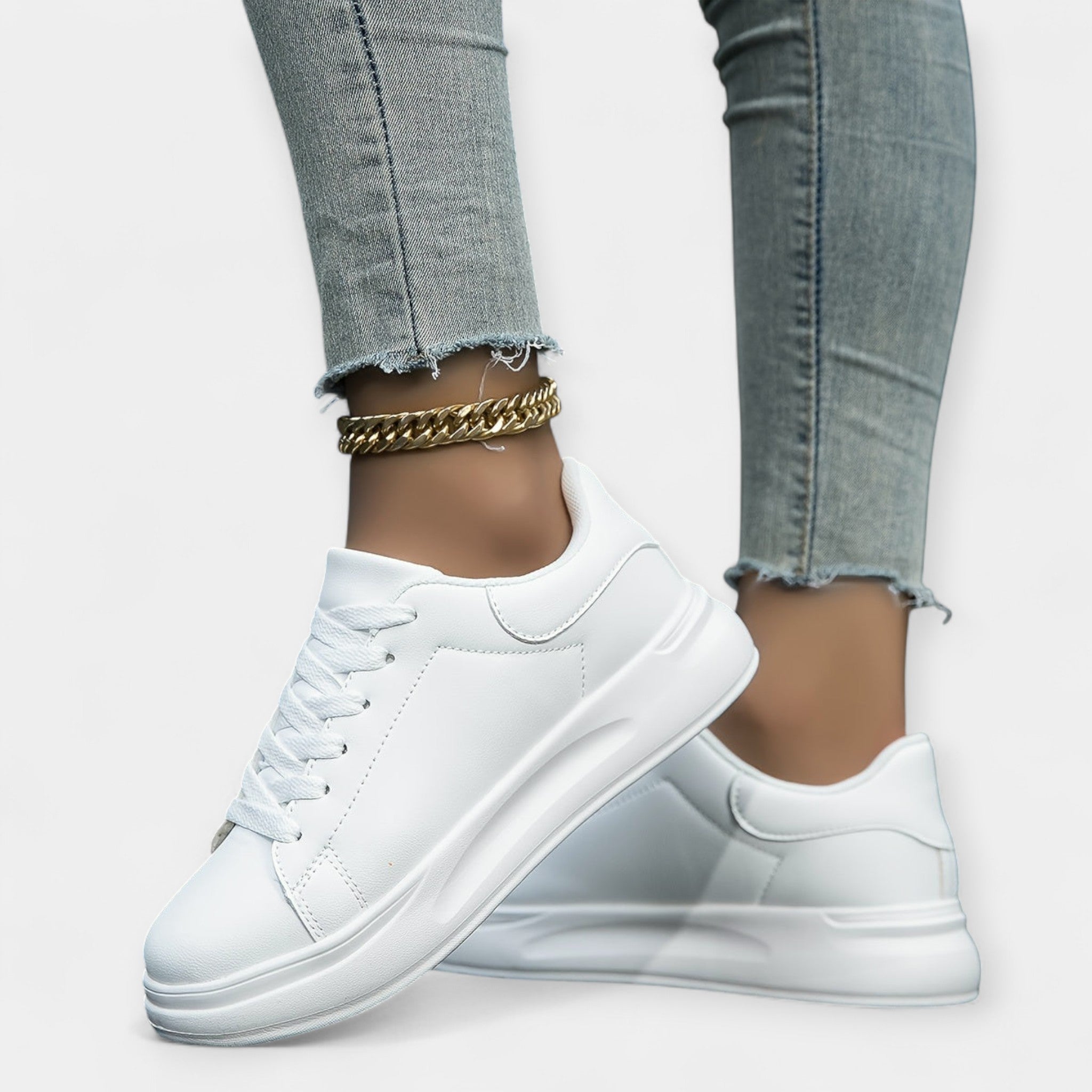 Women's classic white trainers with a clean minimal design and cushioned support sole