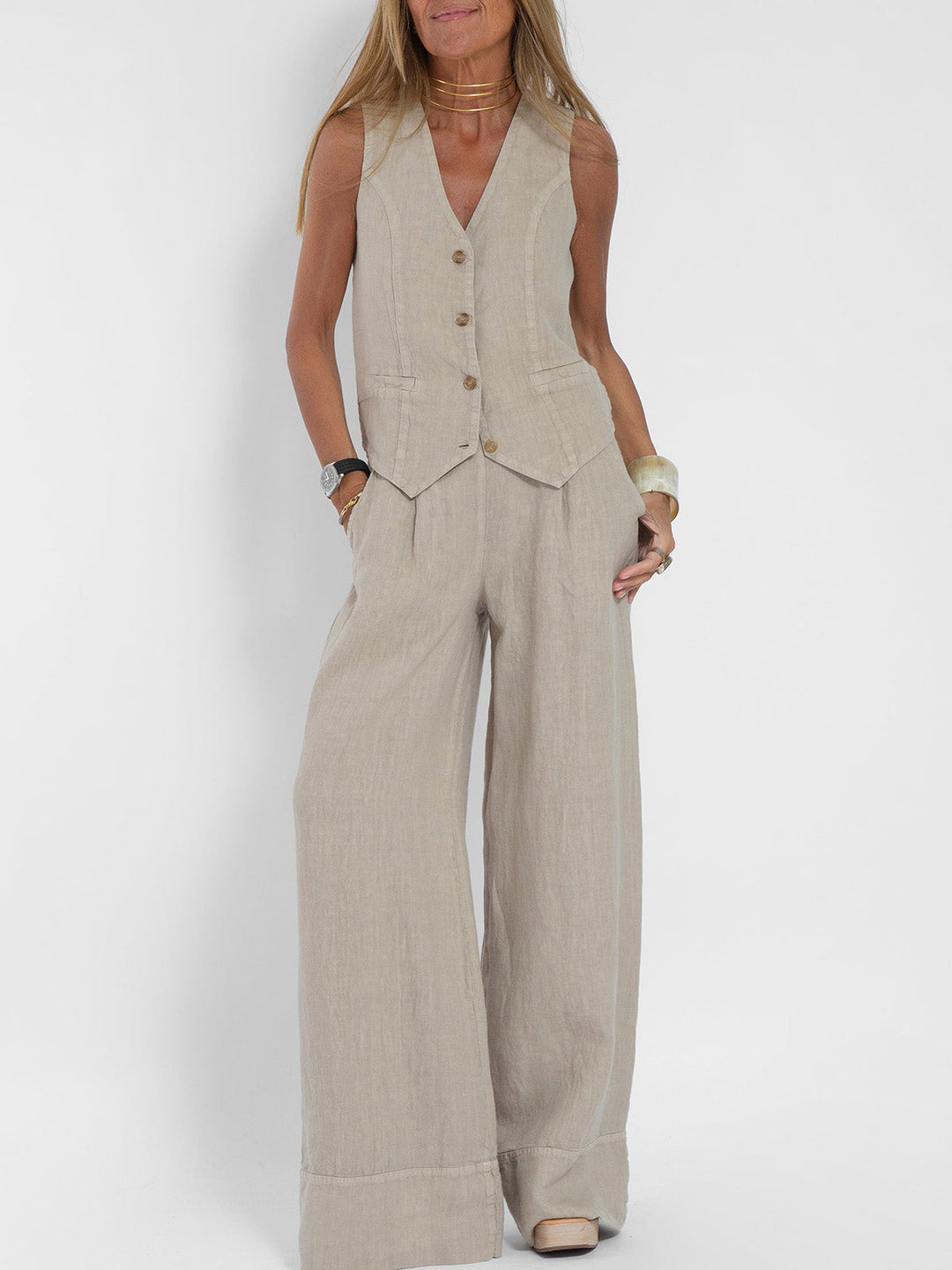 A woman wearing a tailored waistcoat with flowing wide-leg trousers