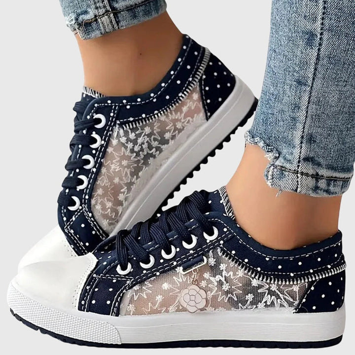 A woman walking comfortably in blue cushioned orthopaedic trainers